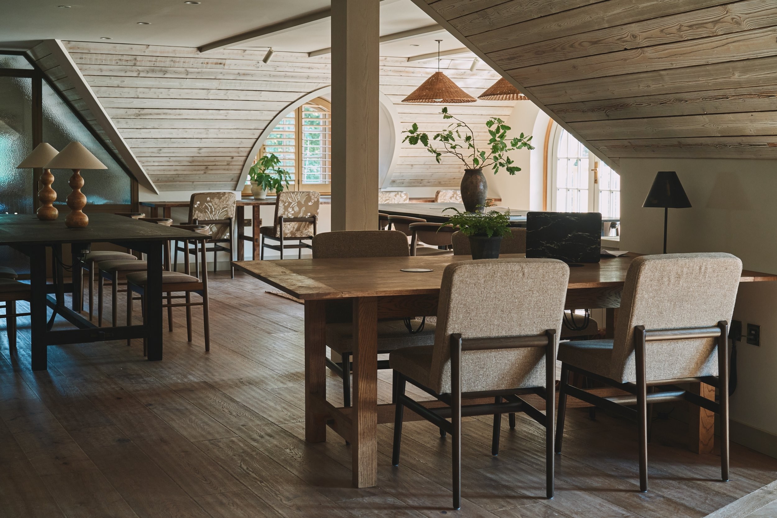 Photo of a study hall with wooden tables and chairs.