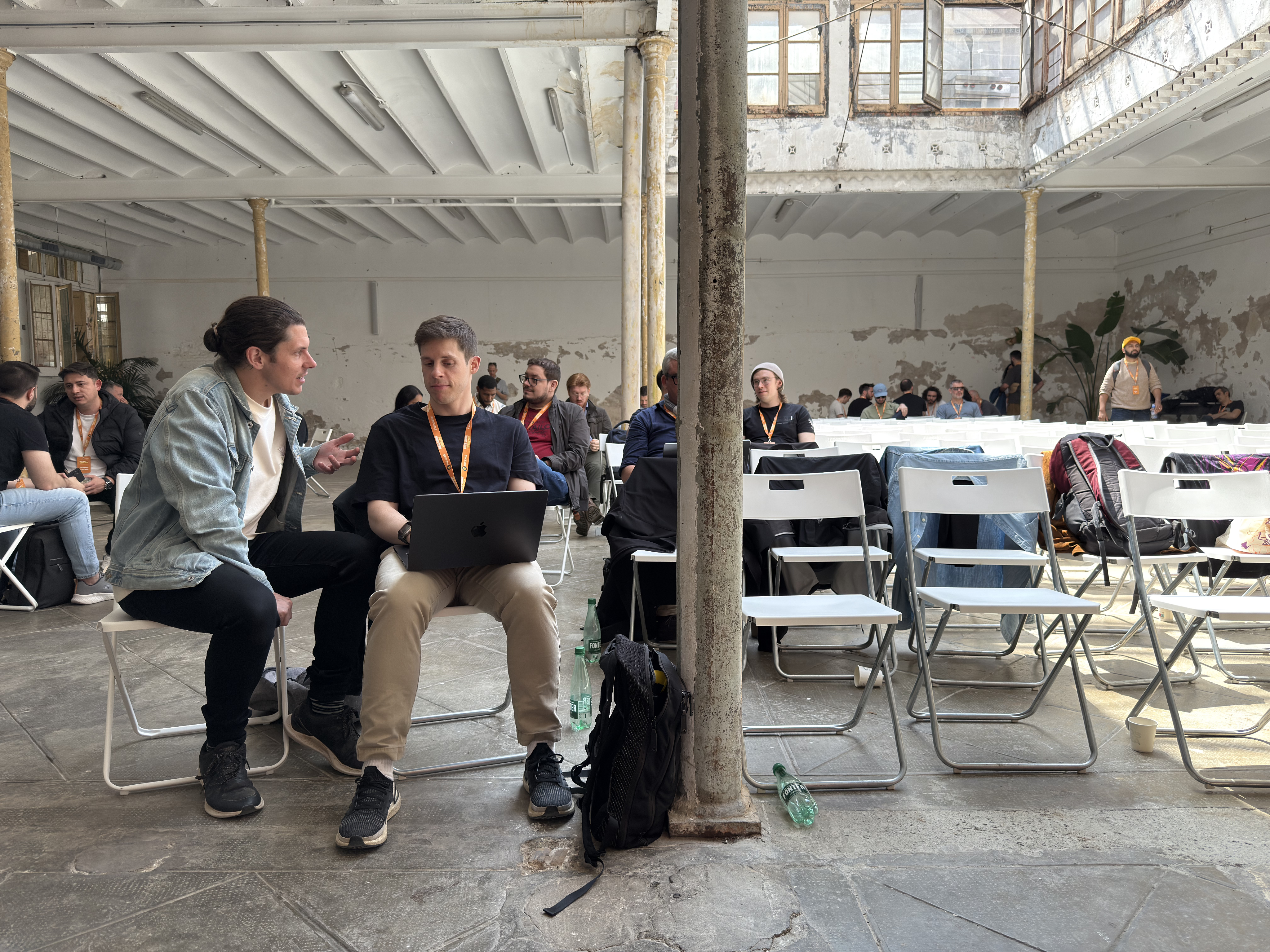 Photo of rows of books in a library with marble busts.